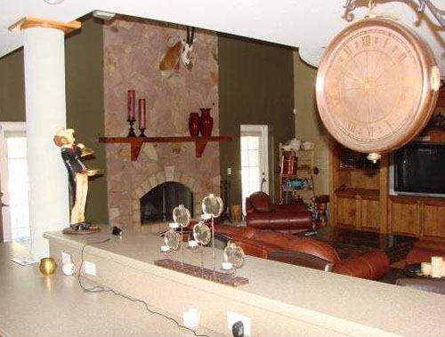 Here's another one where the living room should be the main focus of the photo--not the clock, the candles, the statue, the wires, and the counter.  Taking this on the other side of the counter would have been a much better idea.  This is a $1,399,000 listing in Florida.