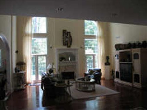 It's such a shame to not showcase a beautiful room like this with such great windows in a way that will attract buyers.  This one really misses the mark...not only has it been shot too far away and directly at the large windows, making them appear very bright and the rest of the room appear a little darker, but it is also very blurry-- not a good way to attract a lot of luxury buyers.  This is a $1,999,999 listing in Georgia.   