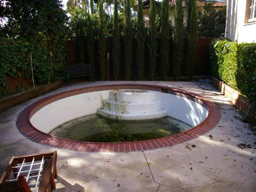 LOL!  Ok, I get that hot tubs are a selling point... but seriously, a close-up of that nasty green water is looking far removed from a relaxing spa...more like a huge, gross headache!  This is a $950,000 listing in California